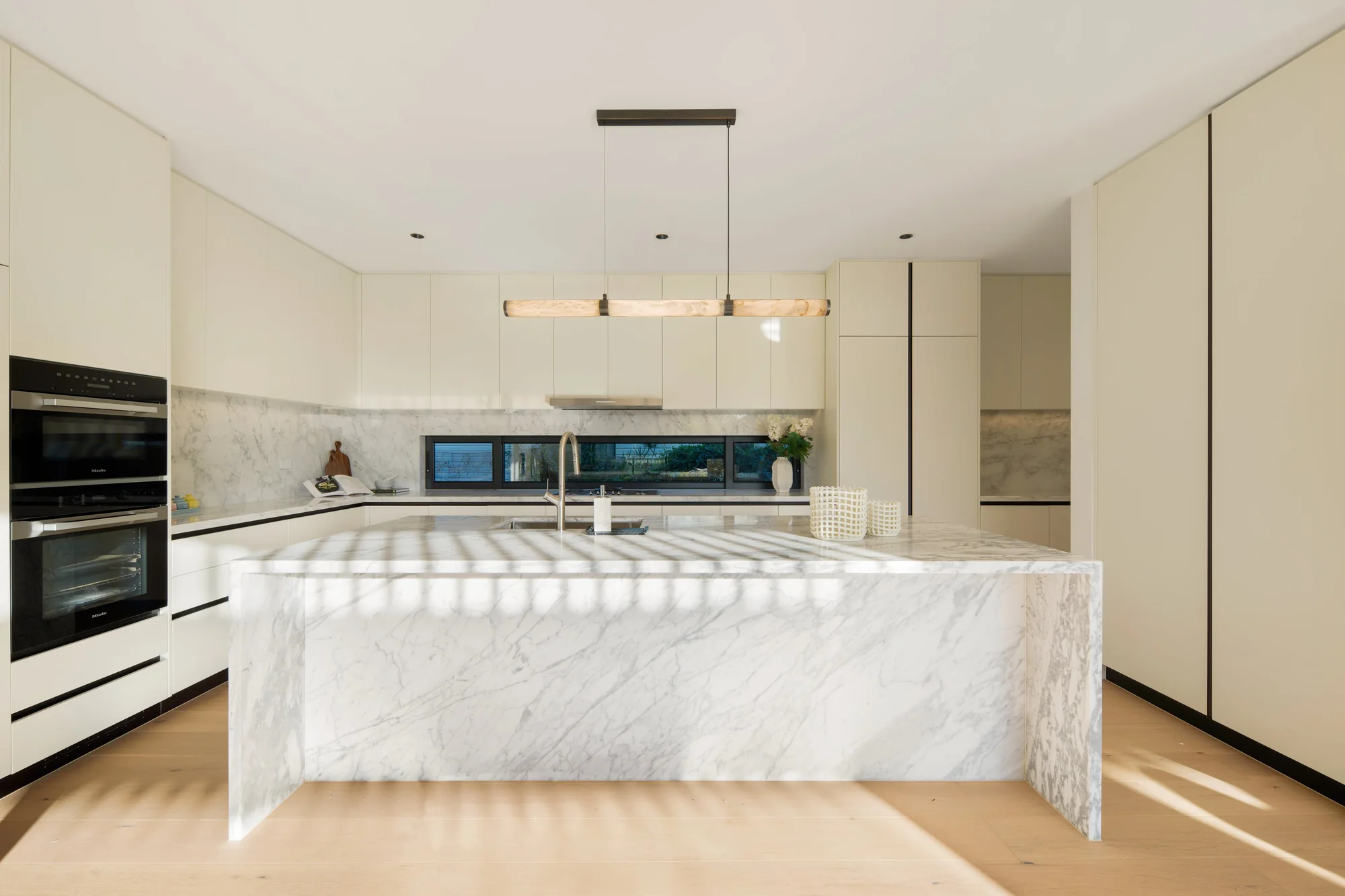 Gladesville kitchen with a stone island and full-height joinery